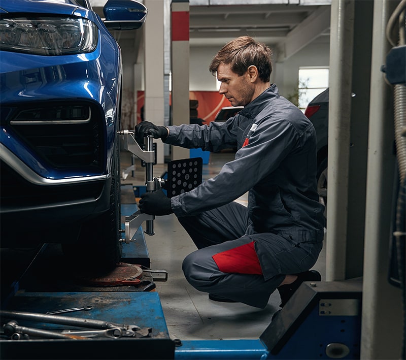 Mechanic Aligning Wheel