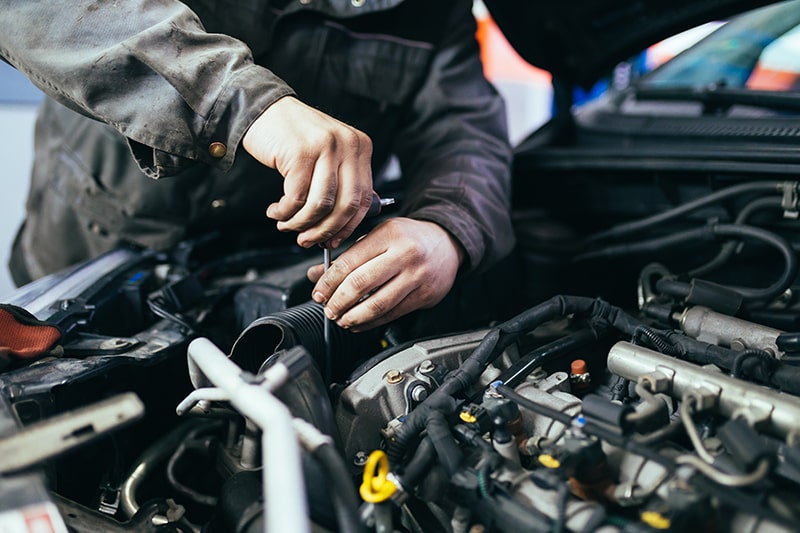 Mechanic Fixing Car Engine