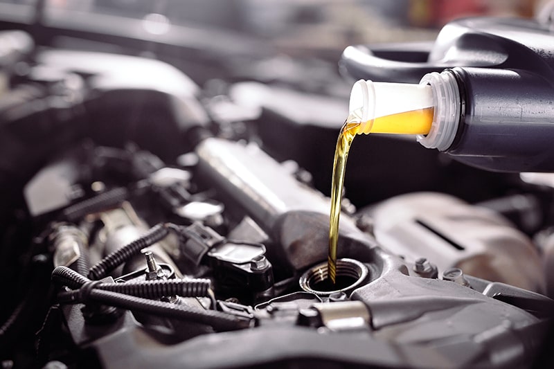 Mechanic Changing Car Engine Oil