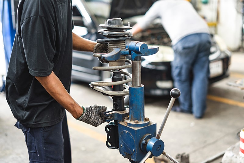 Mechanic Fixing Car Shock